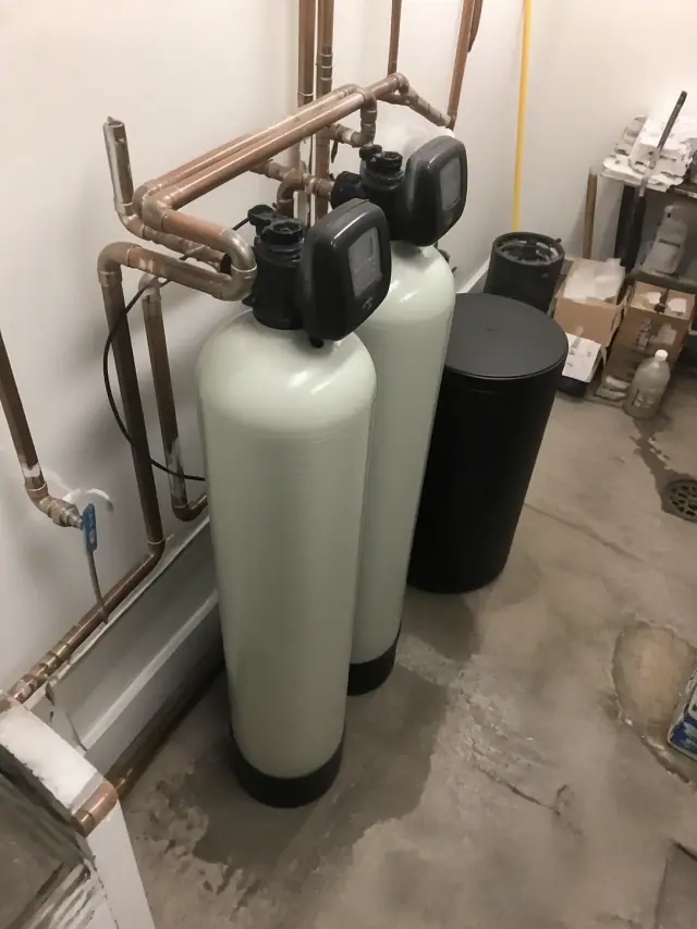 Commercial water softener system with copper piping installed in a utility room in Phoenix, AZ.