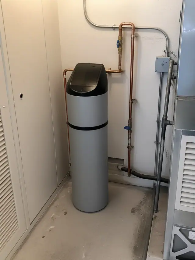 Saltless water softener installed with copper piping in a Phoenix, AZ apartment mechanical room.