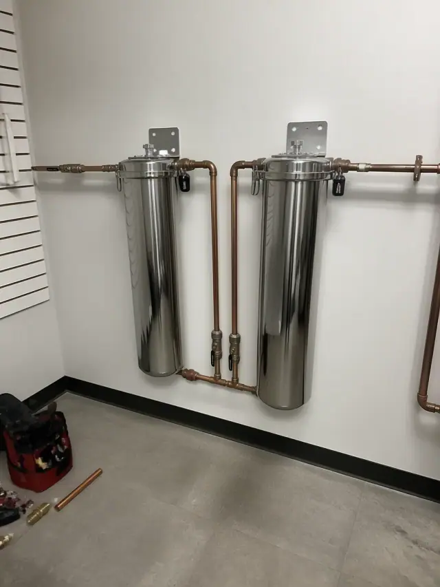Stainless steel carbon filtration system with copper piping installed in a Mesa, AZ retail backroom.
