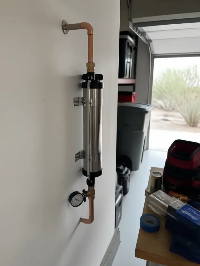 Single-stage TAC water conditioner installed with copper pipes in a Mesa, AZ garage.