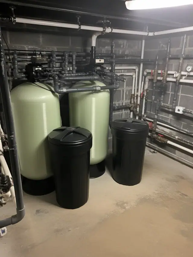 Commercial twin-tank water softener installation with industrial piping in a mechanical room in Mesa, AZ.