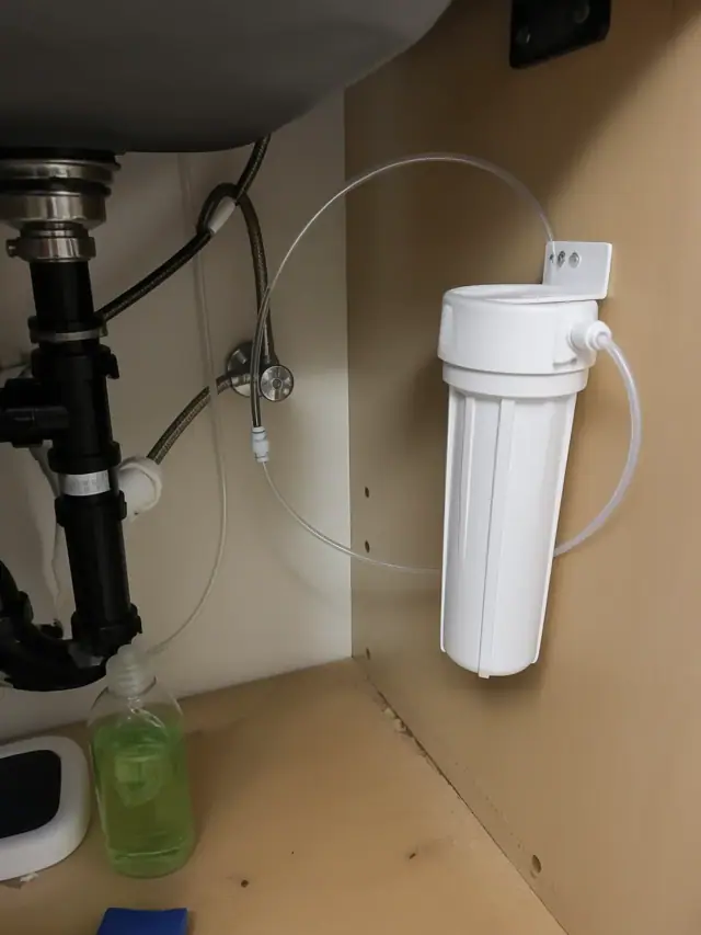Water filtration system installed under a kitchen sink in a Mesa, AZ home.