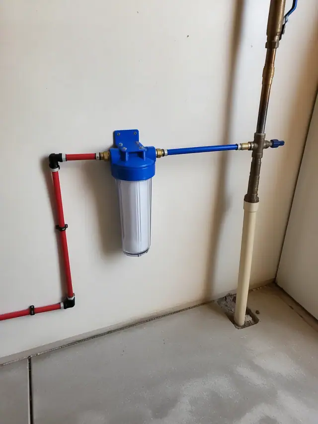 A completed water filtration system with PEX piping installed on a garage wall in Mesa, AZ.