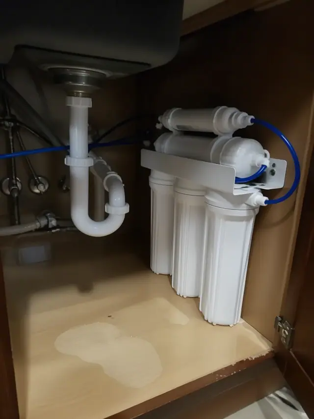 Reverse osmosis water filtration system installed under a kitchen cabinet in Phoenix, AZ.