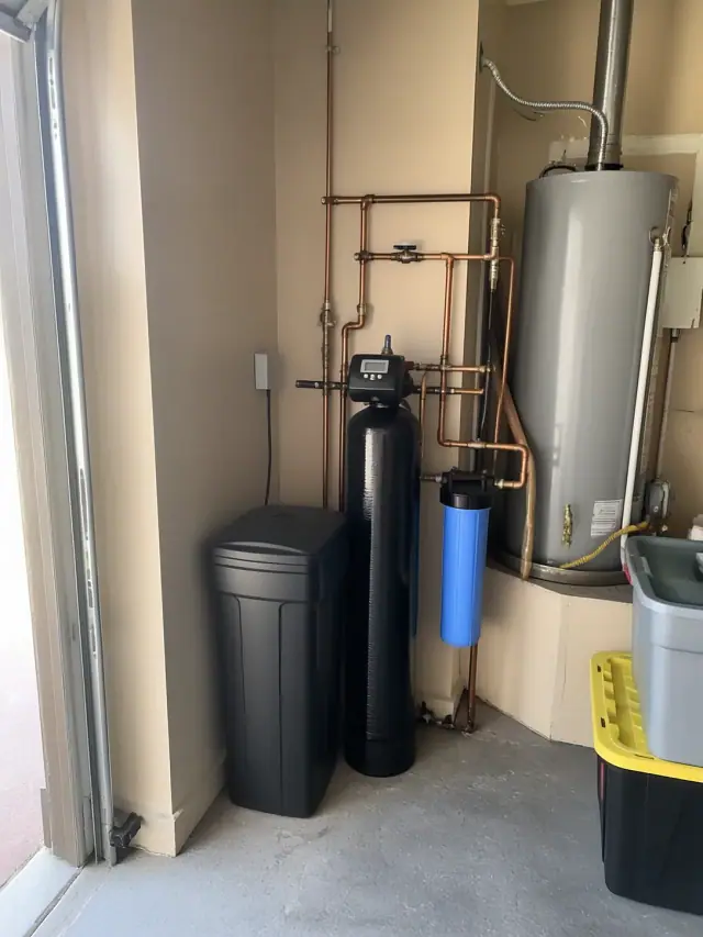 Newly installed water softener and filtration system with copper piping in an Ahwatukee, AZ garage.