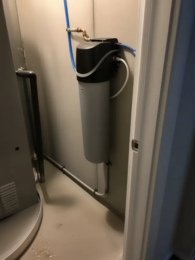 Saltless water softener installed on a mechanical closet wall in Gilbert, AZ.