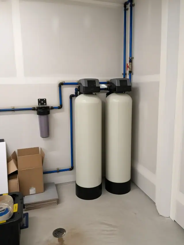 Two water filtration tanks installed with PEX piping in a Mesa, AZ garage.