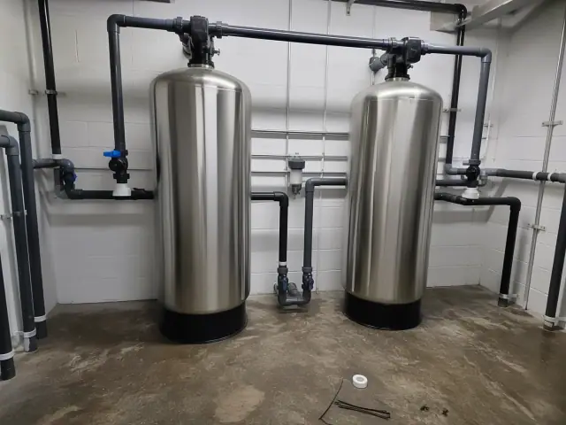 Two industrial water filtration tanks installed in a mechanical room in Mesa, AZ.