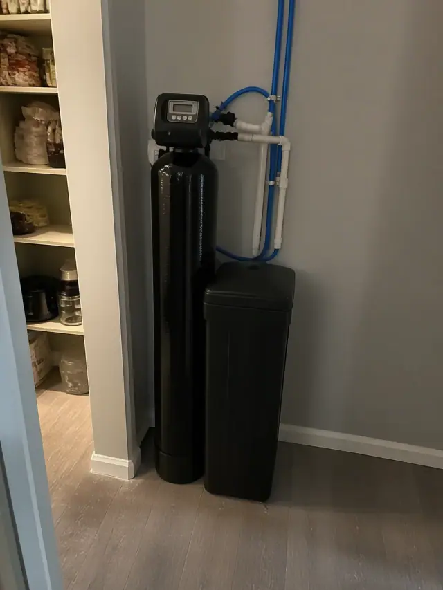 Newly installed water softener and carbon filtration system in a Mesa, AZ home pantry.