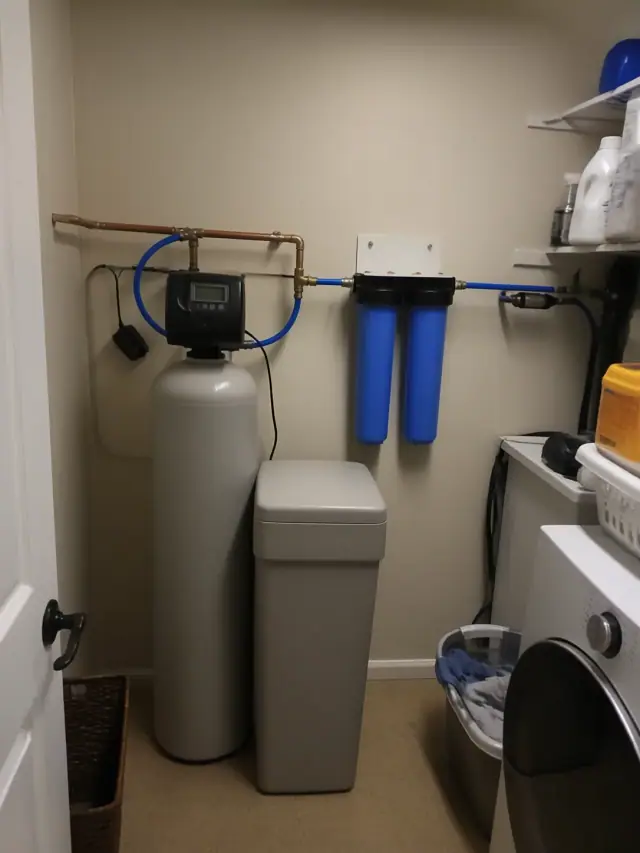 Whole-house water softener and filtration system installed in a residential laundry room in Ahwatukee, AZ.