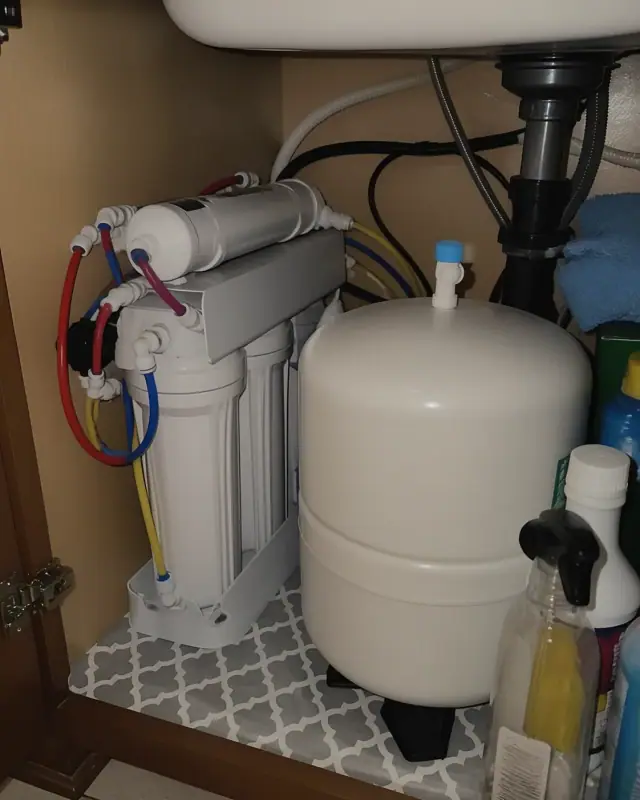 Reverse osmosis water filtration system installed under a kitchen sink in Gilbert, AZ.