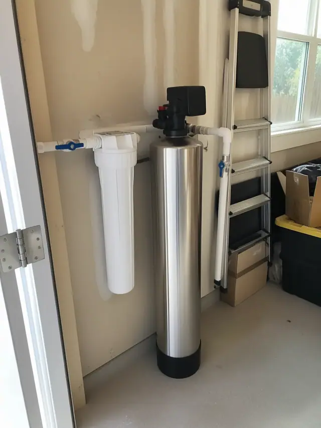 Water filtration system with a stainless steel tank and sediment filter installed in a residential garage in Mesa, AZ.