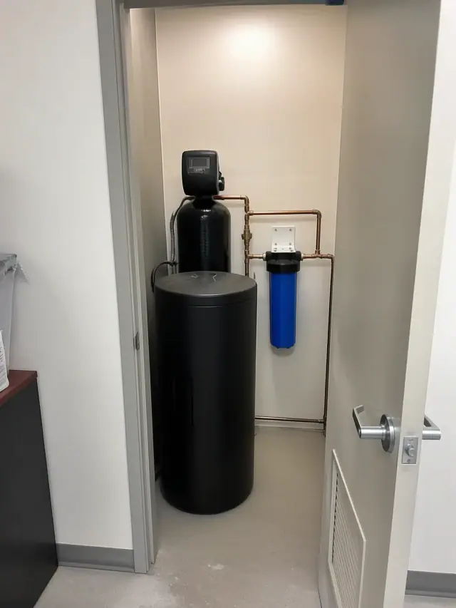 Water softener and filtration system with copper piping installed in a utility closet in Peoria, AZ.