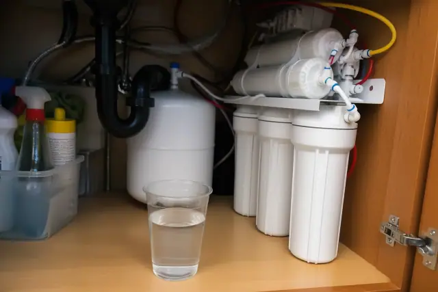 Under-sink reverse osmosis water filtration system installed in a kitchen cabinet in Mesa, AZ.