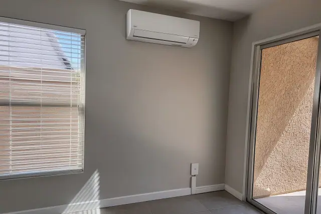Indoor ductless air conditioning unit mounted on a wall in a Phoenix, AZ home.