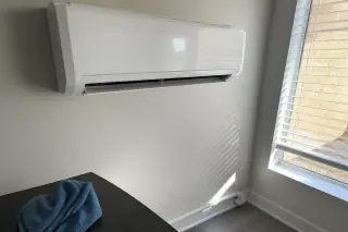 Microfiber cloth resting near a cleaned wall-mounted mini split unit in a Phoenix, AZ home.