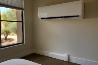 Wall-mounted mini split unit with clean refrigerant line conduit in a Phoenix, AZ home.