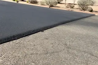 Asphalt overlay seam showing a smooth transition between new and old pavement in Peoria, AZ.