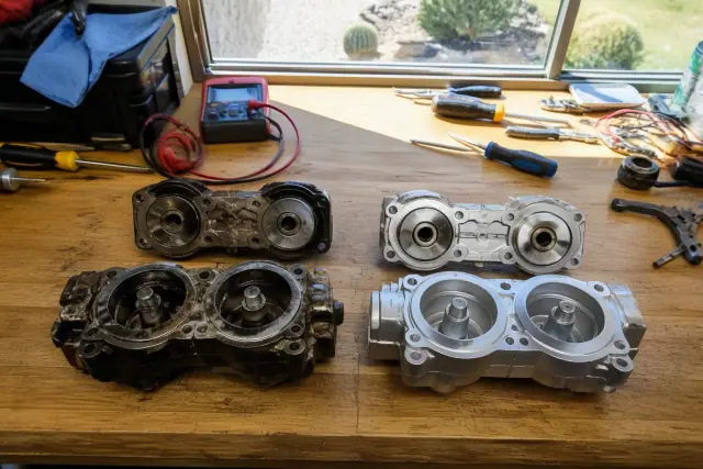 Before and after mechanical parts on a workbench in a Phoenix, AZ workshop.