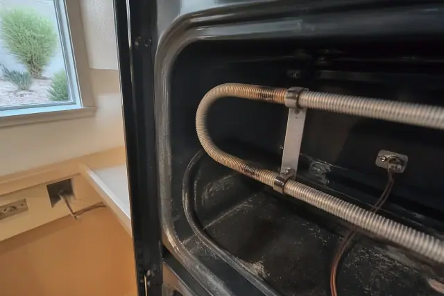 Broken heating element in an oven cabinet cutout at a jobsite in Phoenix, AZ.