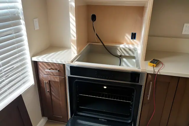 Convection and self-cleaning oven being installed in a custom cabinet cutout in Phoenix, AZ.