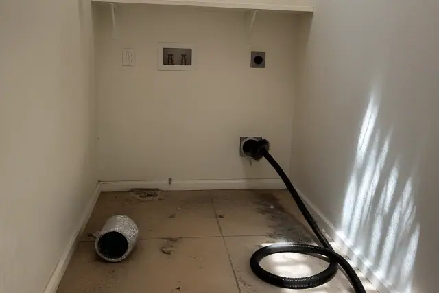 Dryer vent cleaning equipment inside a laundry closet at a residential property in Phoenix, AZ.