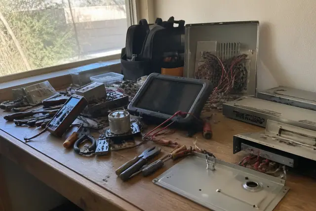 Technician's workbench with stove range repair tools and diagnostic equipment in Phoenix, AZ.