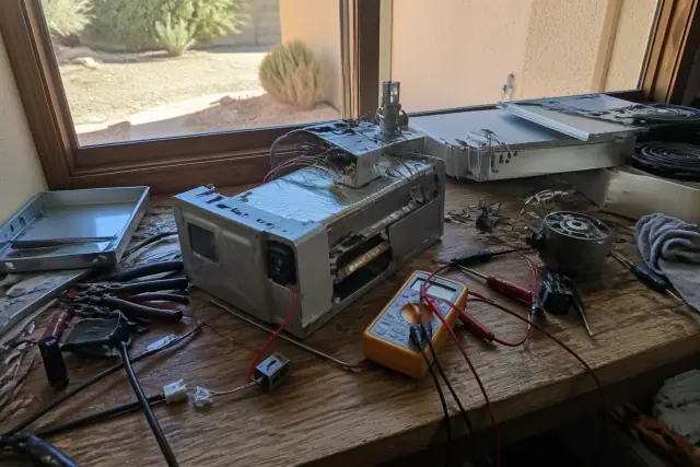 Oven repair workbench with tools and disassembled components in Phoenix, AZ.