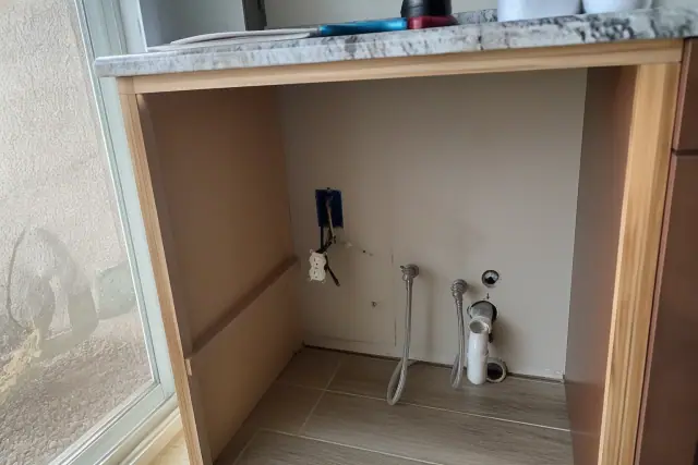 Plumbing and electrical connections for a kitchen appliance installation in a Phoenix, AZ home.