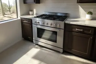 Freestanding stainless steel stove installed against a kitchen wall with desert views in Phoenix, AZ.