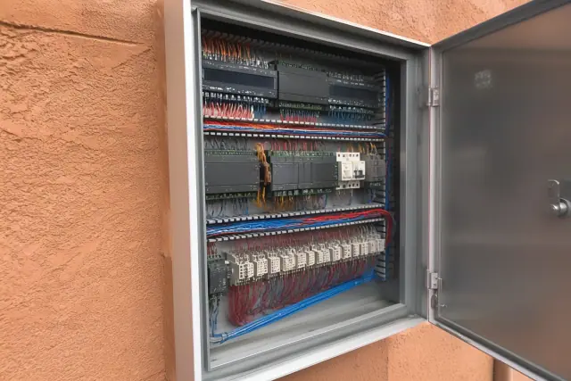 Building automation control cabinet with color-coded wiring inside a commercial building in Phoenix, AZ.