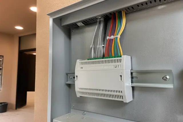 Building automation gateway with ethernet cables mounted in a cabinet at a jobsite in Phoenix, AZ.