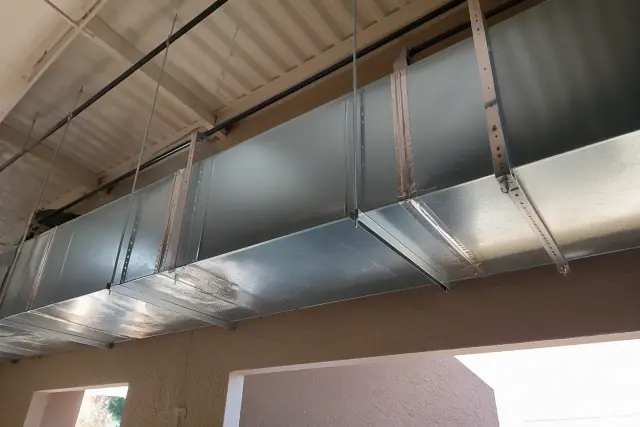 Galvanized steel ductwork installation suspended from an industrial ceiling in Phoenix, AZ.