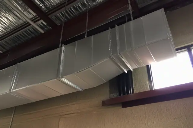 Galvanized steel ductwork hanging from an industrial ceiling in Phoenix, AZ.