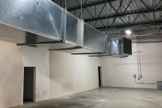 Galvanized steel ductwork installation suspended from an industrial ceiling at a job site in Phoenix, AZ.