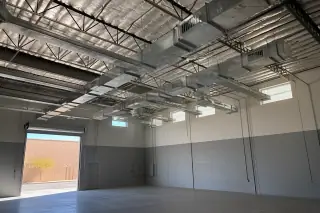 Finished galvanized steel ductwork installed on a warehouse ceiling in Phoenix, AZ.
