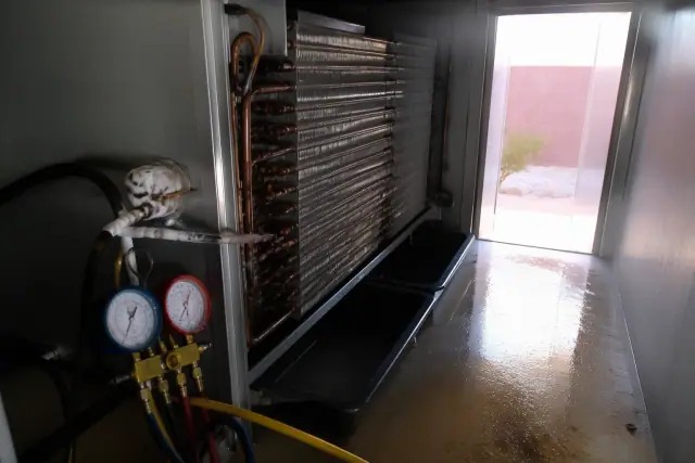 Copper evaporator coil with soldered joints and manifold gauges inside a walk-in cooler in Phoenix, AZ.