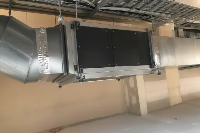 HEPA air purification unit being installed into commercial ductwork at a jobsite in Glendale, AZ.