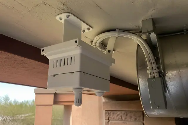 Air quality sensor mounted to a ceiling bracket in a Phoenix, AZ commercial building.