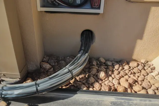 Control cabling for HVAC building automation integrated into a stucco wall at a commercial site in Phoenix, AZ.