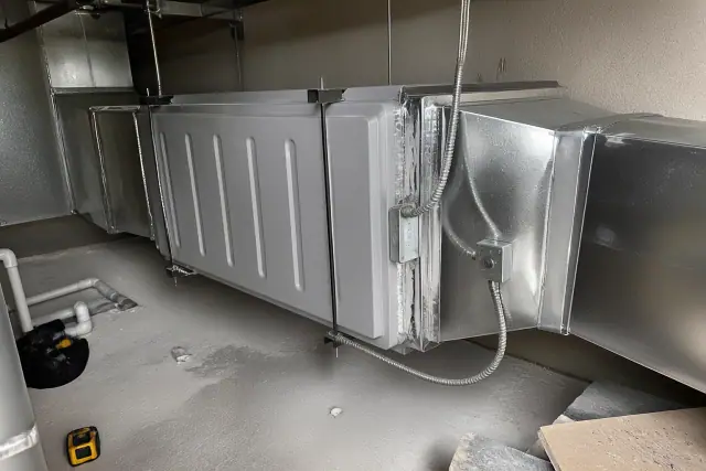 Commercial air purification unit installed in industrial ductwork at a jobsite in Phoenix, AZ.