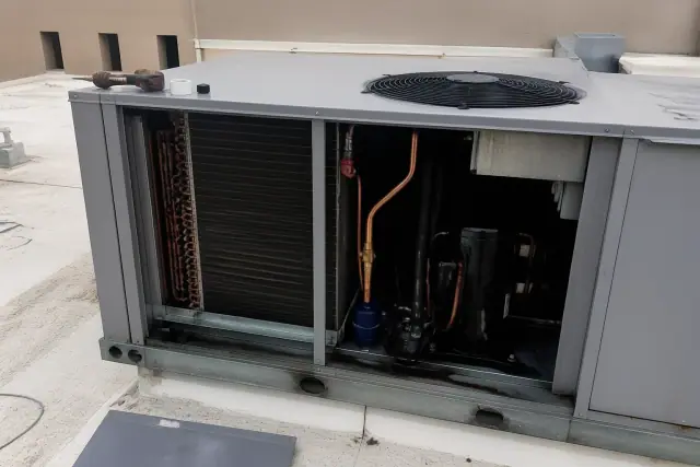 Technician performing a commercial refrigeration system replacement on a rooftop in Phoenix, AZ.