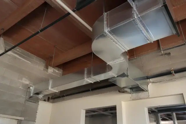 Galvanized steel kitchen exhaust ducts installed in a commercial building in Phoenix, AZ.