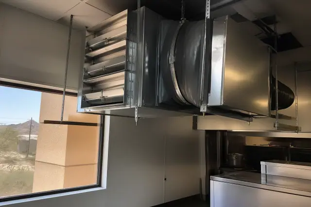 Makeup air unit with duct dampers and vibration collars installed in a commercial kitchen in Phoenix, AZ.