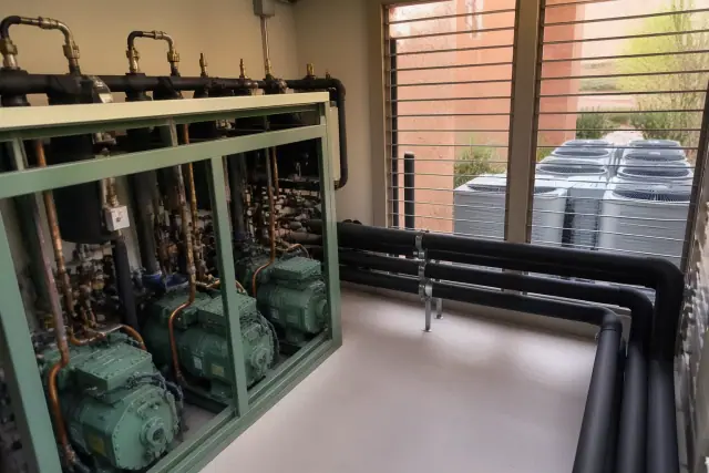 Commercial refrigeration rack and remote condensing systems with insulated copper pipes in a Phoenix, AZ mechanical room.