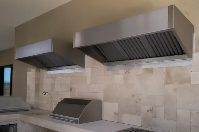 Type II heat and steam hoods installed above a kitchen prep area in Phoenix, AZ with a travertine backsplash.