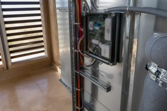 Control wires and HVAC equipment on a strut support inside a building in Phoenix, AZ.