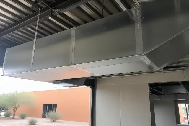 Galvanized steel ductwork suspended from an industrial ceiling at a jobsite in Phoenix, AZ.