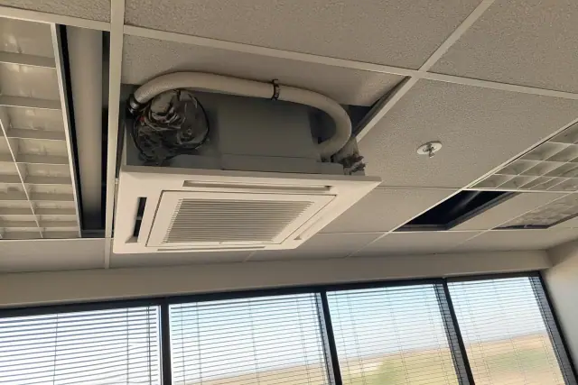 Ceiling-mounted VRF indoor unit installation in a Phoenix, AZ office with exposed wiring and refrigerant lines.