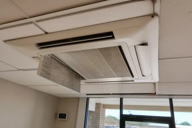 Ceiling-mounted VRF unit with a cleaned filter and access panel in a commercial office space in Surprise, AZ.